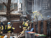 Firefighters are extinguishing a fire that has broken out at the commercial complex of Yeouido Gongjak Apartments in Seoul, South Korea, on...