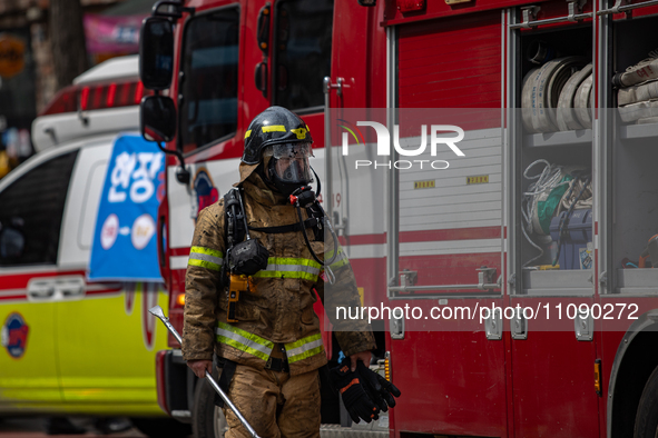 Firefighters are extinguishing a fire that has broken out at the commercial complex of Yeouido Gongjak Apartments in Seoul, South Korea, on...