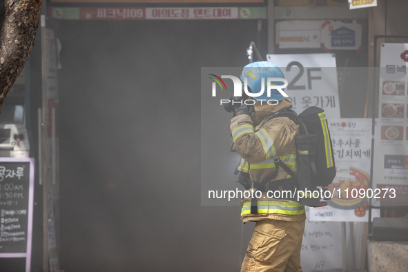 Firefighters are extinguishing a fire that has broken out at the commercial complex of Yeouido Gongjak Apartments in Seoul, South Korea, on...