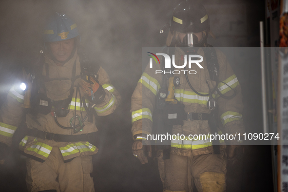 Firefighters are extinguishing a fire that has broken out at the commercial complex of Yeouido Gongjak Apartments in Seoul, South Korea, on...