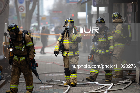 Firefighters are extinguishing a fire that has broken out at the commercial complex of Yeouido Gongjak Apartments in Seoul, South Korea, on...