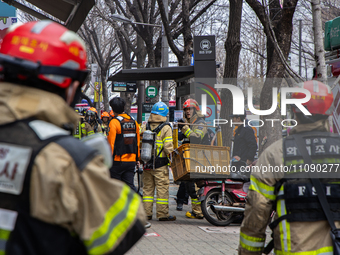 Firefighters are extinguishing a fire that has broken out at the commercial complex of Yeouido Gongjak Apartments in Seoul, South Korea, on...