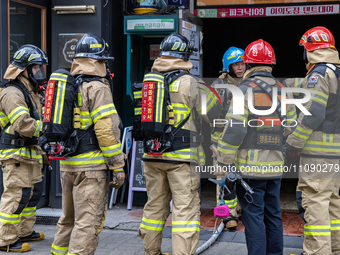 Firefighters are extinguishing a fire that has broken out at the commercial complex of Yeouido Gongjak Apartments in Seoul, South Korea, on...