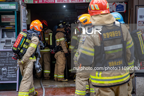 Firefighters are extinguishing a fire that has broken out at the commercial complex of Yeouido Gongjak Apartments in Seoul, South Korea, on...