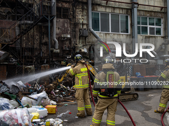 Firefighters are extinguishing a fire that has broken out at the commercial complex of Yeouido Gongjak Apartments in Seoul, South Korea, on...