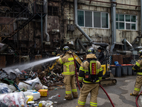 Firefighters are extinguishing a fire that has broken out at the commercial complex of Yeouido Gongjak Apartments in Seoul, South Korea, on...