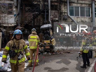 Firefighters are extinguishing a fire that has broken out at the commercial complex of Yeouido Gongjak Apartments in Seoul, South Korea, on...