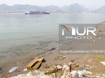 Debris is floating downstream, brought by the 2023 Yangtze River flood, near the Linjiangxi Bridge in Yichang on the Yangtze River in Yichan...