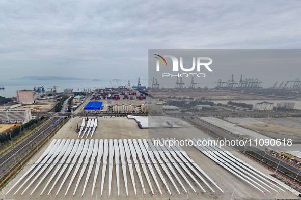 Police officers are guiding the loading of wind power blades at the port of Fuzhou, Fujian province, China, on March 23, 2024. 