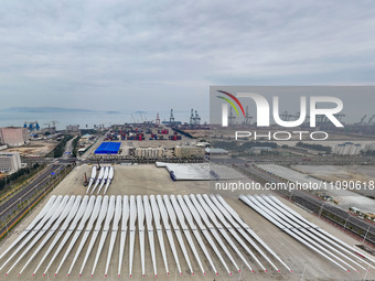 Police officers are guiding the loading of wind power blades at the port of Fuzhou, Fujian province, China, on March 23, 2024. (