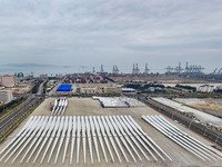 Police officers are guiding the loading of wind power blades at the port of Fuzhou, Fujian province, China, on March 23, 2024. (