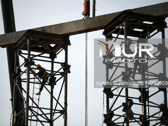 Construction workers are assembling steel structure roof trusses at the east station of Lushan Station of the Anjiu Section of the Beijing-H...