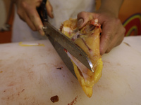 A chicken is being cut into pieces for sale at a market in Mexico City. Recently, the Ministry of Health of Tlaxcala in Mexico issued an epi...