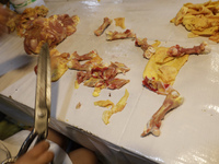 A chicken is being cut into pieces for sale at a market in Mexico City. Recently, the Ministry of Health of Tlaxcala in Mexico issued an epi...