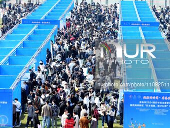 College graduates are attending a job fair in Qingdao, Shandong Province, China, on March 23, 2024. (