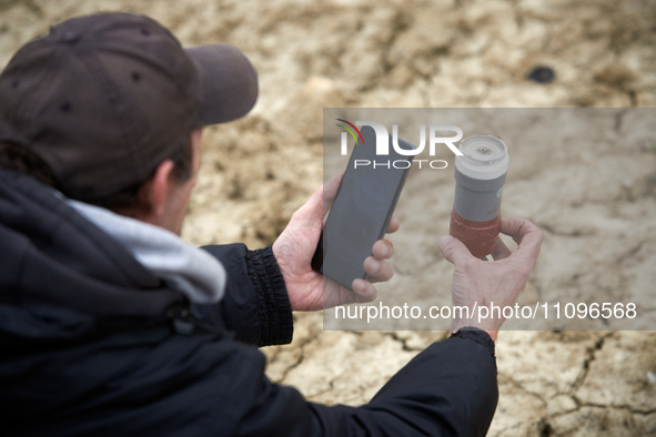 A man is taking a picture of a tear gas canister launched by riot police in the Crem'Arbre woods. After 37 days in the trees, the last three...