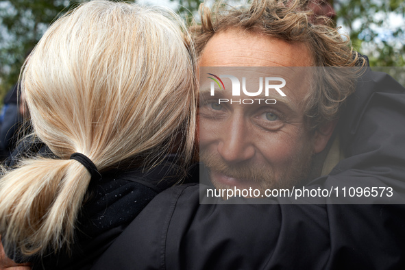 Reva, one of the three 'Ecureuils', is being hugged by a friend. After 37 days in the trees, the last three 'Ecureuils' living in the ZAD (Z...