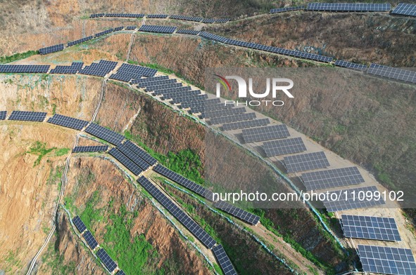 A photovoltaic power generation facility at an abandoned mine is being seen from the air in Hangzhou, Zhejiang Province, China, on March 26,...