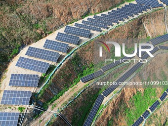 A photovoltaic power generation facility at an abandoned mine is being seen from the air in Hangzhou, Zhejiang Province, China, on March 26,...