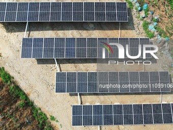 A photovoltaic power generation facility at an abandoned mine is being seen from the air in Hangzhou, Zhejiang Province, China, on March 26,...