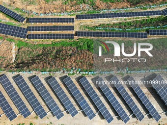 A photovoltaic power generation facility at an abandoned mine is being seen from the air in Hangzhou, Zhejiang Province, China, on March 26,...