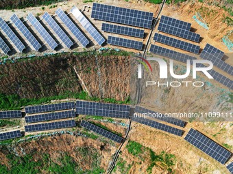 A photovoltaic power generation facility at an abandoned mine is being seen from the air in Hangzhou, Zhejiang Province, China, on March 26,...