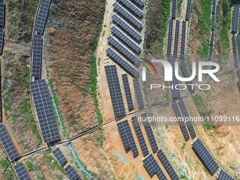 A photovoltaic power generation facility at an abandoned mine is being seen from the air in Hangzhou, Zhejiang Province, China, on March 26,...