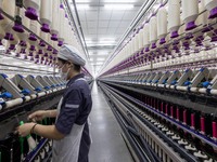 A worker is operating an intelligent production line at a textile company in Taizhou, Jiangsu Province, China, on March 26, 2024. (