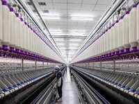 A worker is operating an intelligent production line at a textile company in Taizhou, Jiangsu Province, China, on March 26, 2024. (