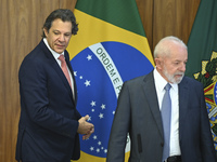 Brazil's President Luiz Inacio Lula da Silva and Finance Minister Fernando Haddad are participating in a ceremony at the Planalto Palace in...
