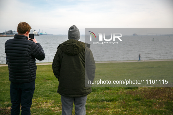 People view the collapsed Francis Scott Key Bridge in Baltimore, Maryland from the Fort McHenry National Monument and Historic Shrine on Mar...