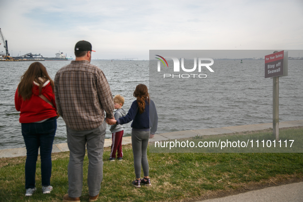 People view the collapsed Francis Scott Key Bridge in Baltimore, Maryland from the Fort McHenry National Monument and Historic Shrine on Mar...