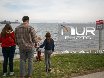 People view the collapsed Francis Scott Key Bridge in Baltimore, Maryland from the Fort McHenry National Monument and Historic Shrine on Mar...