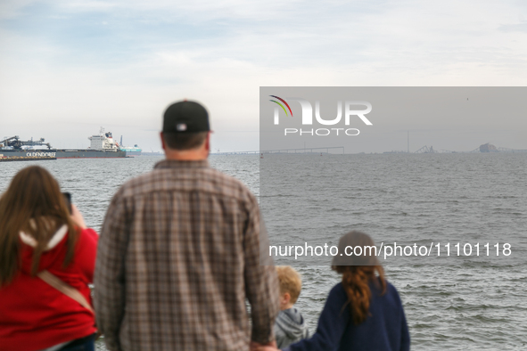 People view the collapsed Francis Scott Key Bridge in Baltimore, Maryland from the Fort McHenry National Monument and Historic Shrine on Mar...