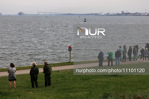 People view the collapsed Francis Scott Key Bridge in Baltimore, Maryland from the Fort McHenry National Monument and Historic Shrine on Mar...