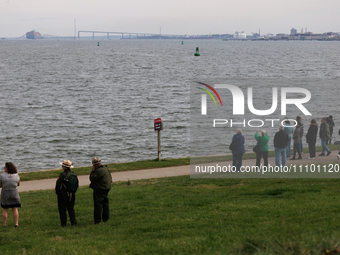 People view the collapsed Francis Scott Key Bridge in Baltimore, Maryland from the Fort McHenry National Monument and Historic Shrine on Mar...