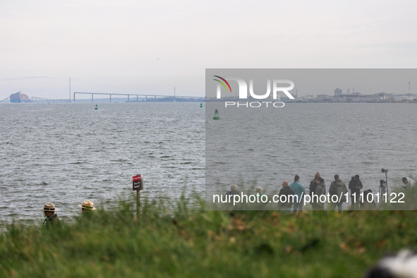 People view the collapsed Francis Scott Key Bridge in Baltimore, Maryland from the Fort McHenry National Monument and Historic Shrine on Mar...