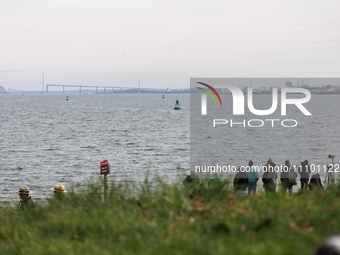 People view the collapsed Francis Scott Key Bridge in Baltimore, Maryland from the Fort McHenry National Monument and Historic Shrine on Mar...