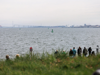 People view the collapsed Francis Scott Key Bridge in Baltimore, Maryland from the Fort McHenry National Monument and Historic Shrine on Mar...