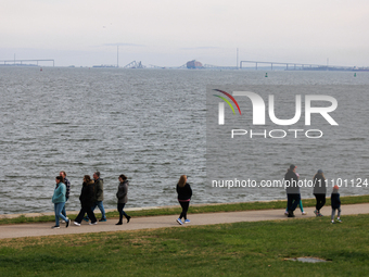 People view the collapsed Francis Scott Key Bridge in Baltimore, Maryland from the Fort McHenry National Monument and Historic Shrine on Mar...