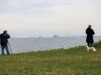 People view the collapsed Francis Scott Key Bridge in Baltimore, Maryland from the Fort McHenry National Monument and Historic Shrine on Mar...