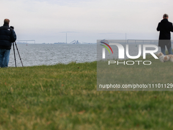 People view the collapsed Francis Scott Key Bridge in Baltimore, Maryland from the Fort McHenry National Monument and Historic Shrine on Mar...