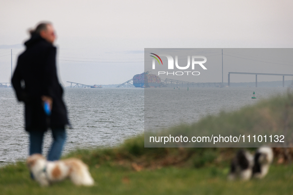 People view the collapsed Francis Scott Key Bridge in Baltimore, Maryland from the Fort McHenry National Monument and Historic Shrine on Mar...