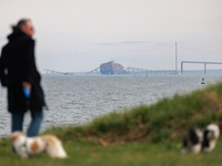 People view the collapsed Francis Scott Key Bridge in Baltimore, Maryland from the Fort McHenry National Monument and Historic Shrine on Mar...