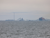 The collapsed Francis Scott Key Bridge is seen from the Fort McHenry National Monument and Historic Shrine in Baltimore, Maryland on March 2...