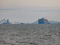 The collapsed Francis Scott Key Bridge is seen from the Fort McHenry National Monument and Historic Shrine in Baltimore, Maryland on March 2...