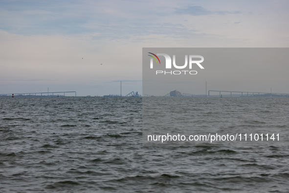 The collapsed Francis Scott Key Bridge is seen from the Fort McHenry National Monument and Historic Shrine in Baltimore, Maryland on March 2...