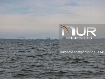 The collapsed Francis Scott Key Bridge is seen from the Fort McHenry National Monument and Historic Shrine in Baltimore, Maryland on March 2...