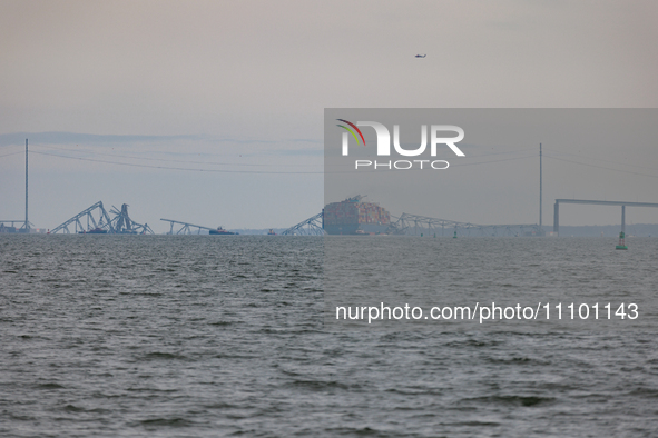 The collapsed Francis Scott Key Bridge is seen from the Fort McHenry National Monument and Historic Shrine in Baltimore, Maryland on March 2...