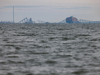 The collapsed Francis Scott Key Bridge is seen from the Fort McHenry National Monument and Historic Shrine in Baltimore, Maryland on March 2...